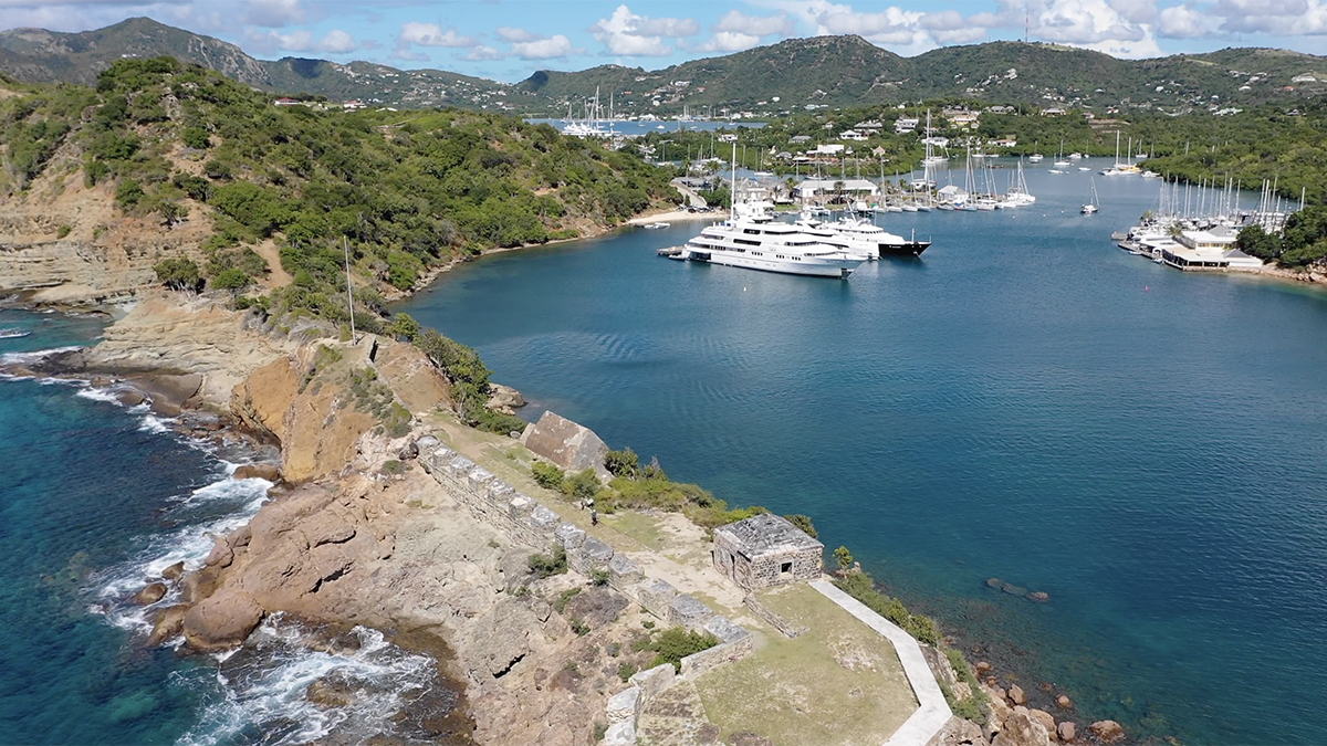 Picturesque view of Antigua's harbor with yachts and colorful buildings