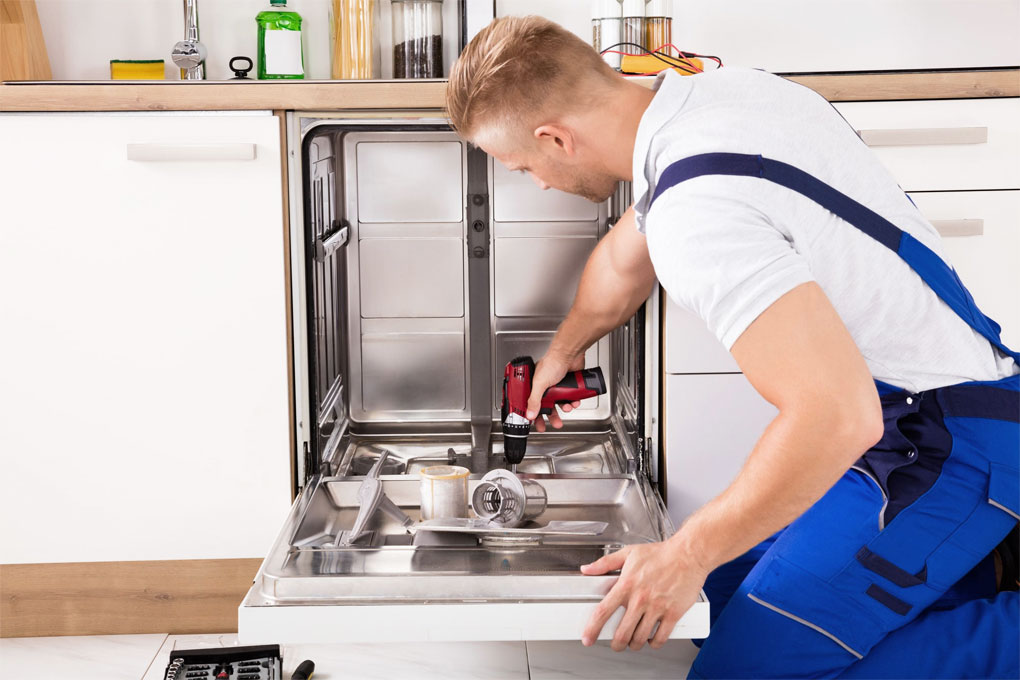 Professional dishwasher installation with stainless steel built-in model plumbing connections and electrical hookup