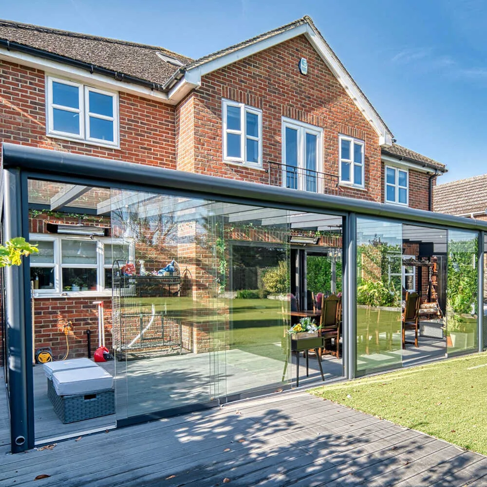 Professional sunroom addition with glass walls, insulated framing, roof system, climate control, and bright indoor-outdoor living space