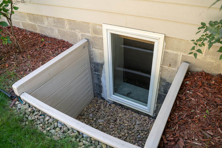 code compliant egress window installation basement emergency exit legal bedroom window well excavation concrete cutting drainage gravel french drain ladder if deeper than 44 inches permit inspection waterproofing flashing pressure treated framing safe escape route
