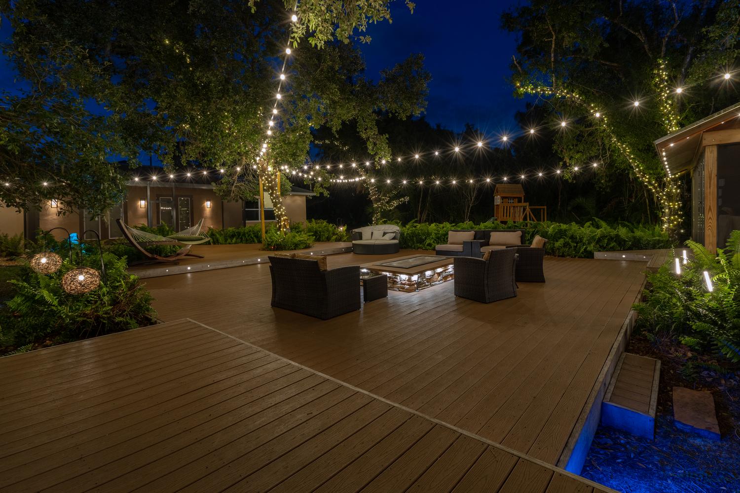 patio lighting string lights cafe lights landscape path lights uplighting trees wall sconces deck step lights outdoor LED lighting smart RGB lighting warm white ambience backyard entertaining lighting design night curb appeal