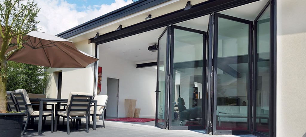 professional bifold door installation folding glass wall system structural header beam engineered support level threshold sill pan flashing tape waterproof membrane thermally broken aluminum low-e glass multipoint lock top hung track bottom rolling track panel alignment hardware adjustment drainage channels