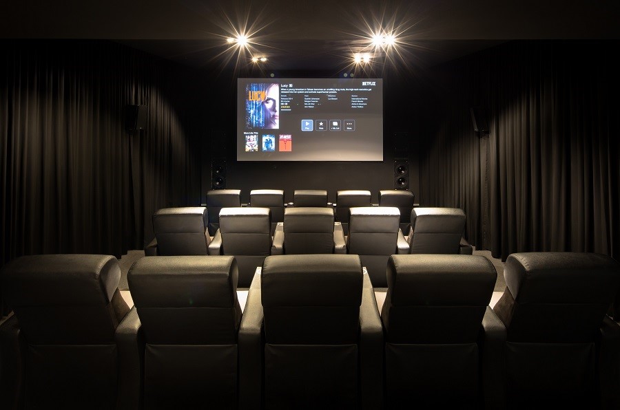 professional home theater installation luxury cinema room projector dolby atmos recliner seating acoustic panels star ceiling lighting automation